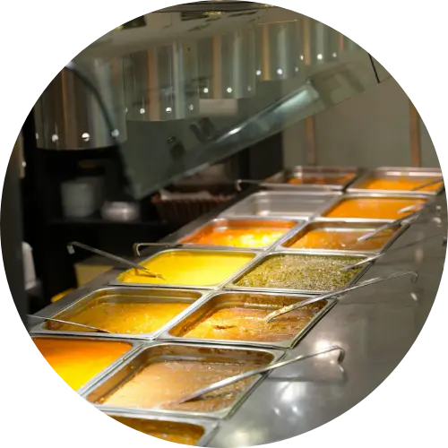 Different types of vegetarian curries are in the containers.
